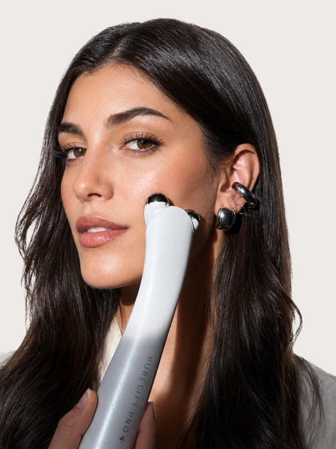 Woman holding PureLift Pro Plus against her cheek